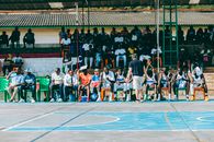 Outdoor basketball game with Urunani BBC team huddling in Bujumbura, Burundi.