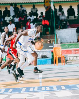 Intense basketball match with players in motion on an outdoor court.