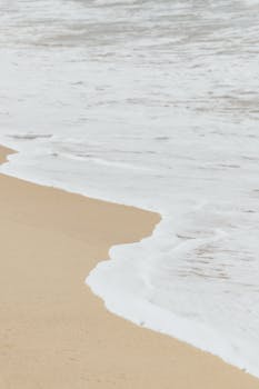 Tranquil view of beach waves meeting the sandy shore in San Francisco, Nayarit, México.