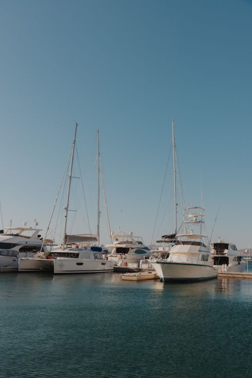 Free Peaceful view of yachts docked in La Paz harbor under a clear blue sky. Stock Photo