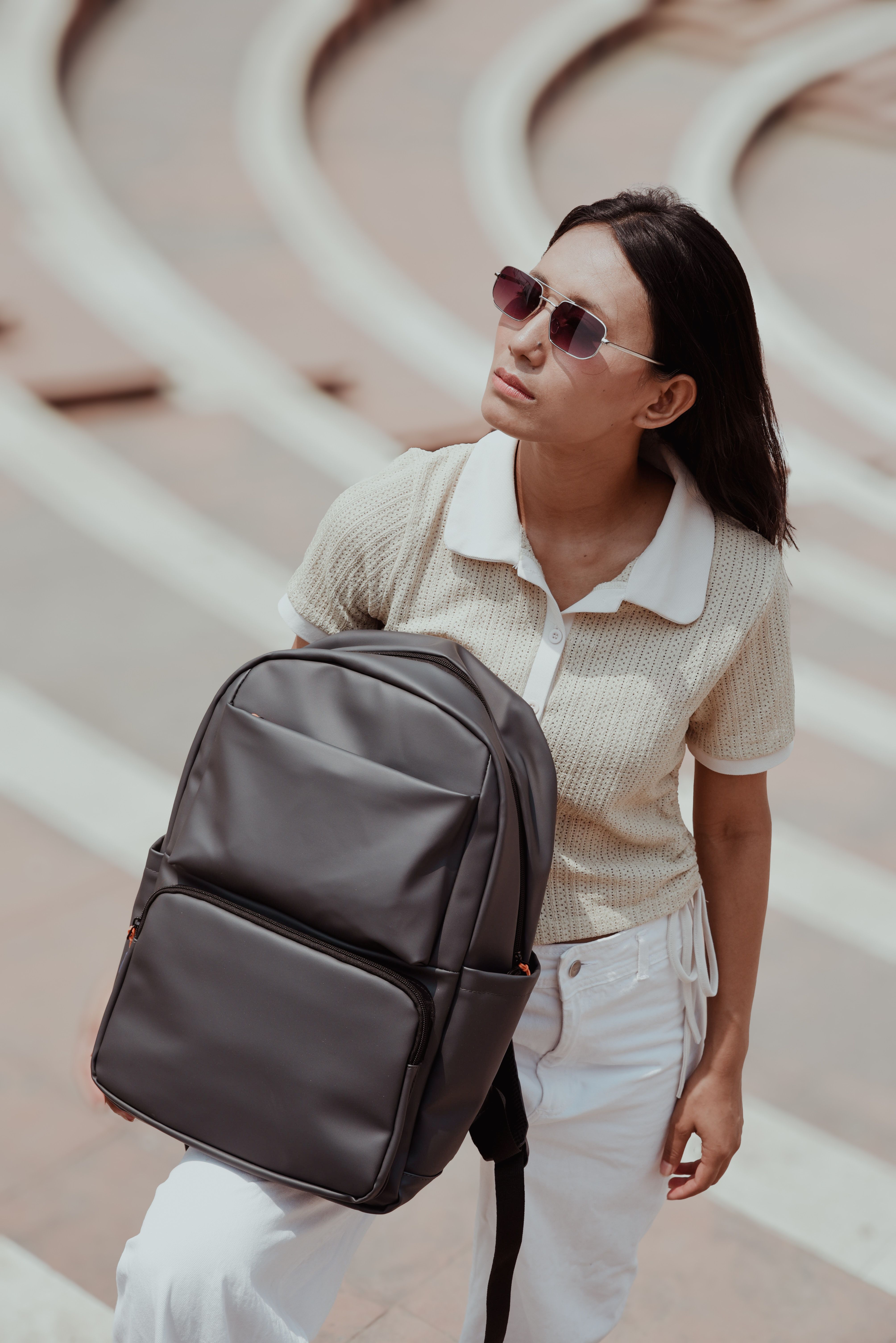 Young Woman Outdoors with Backpack in Summer