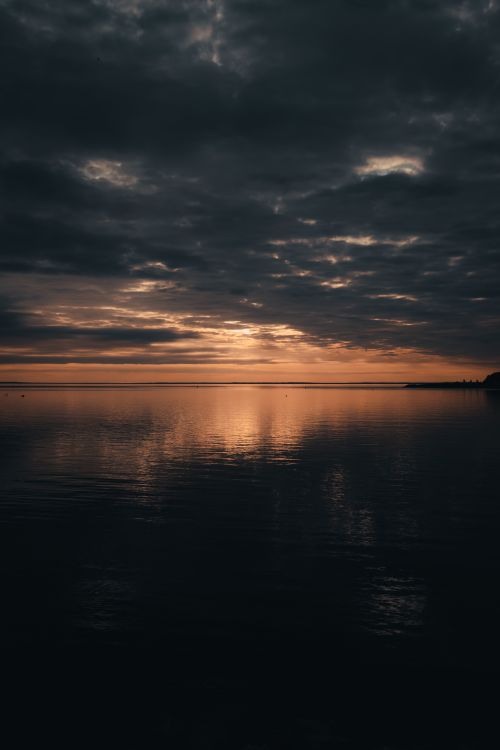 Free Dramatic sunset over Collingwood Lake with serene water reflections and a vibrant sky. Stock Photo