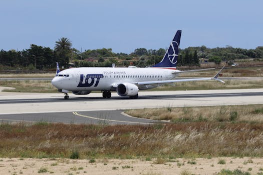LOT Polish Airlines aircraft preparing for takeoff on a sunny day.