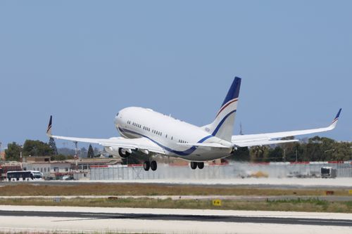 Free A commercial airplane takes off from a runway on a clear day, showcasing aviation and travel concepts. Stock Photo
