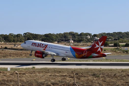 An Air Malta Airbus A320 takes off from the runway amidst a clear day.