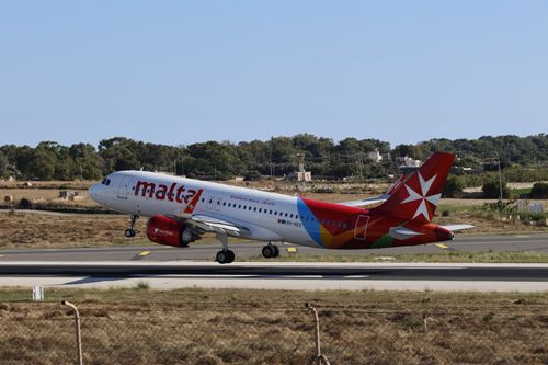 Free An Air Malta Airbus A320 takes off from the runway amidst a clear day. Stock Photo