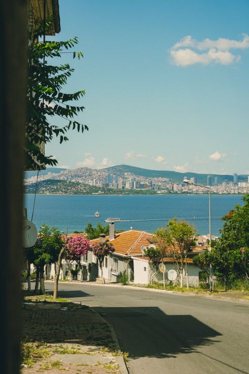 Free A serene view of Izmir's urban landscape with mountains in the backdrop and the coastline in the foreground. Stock Photo