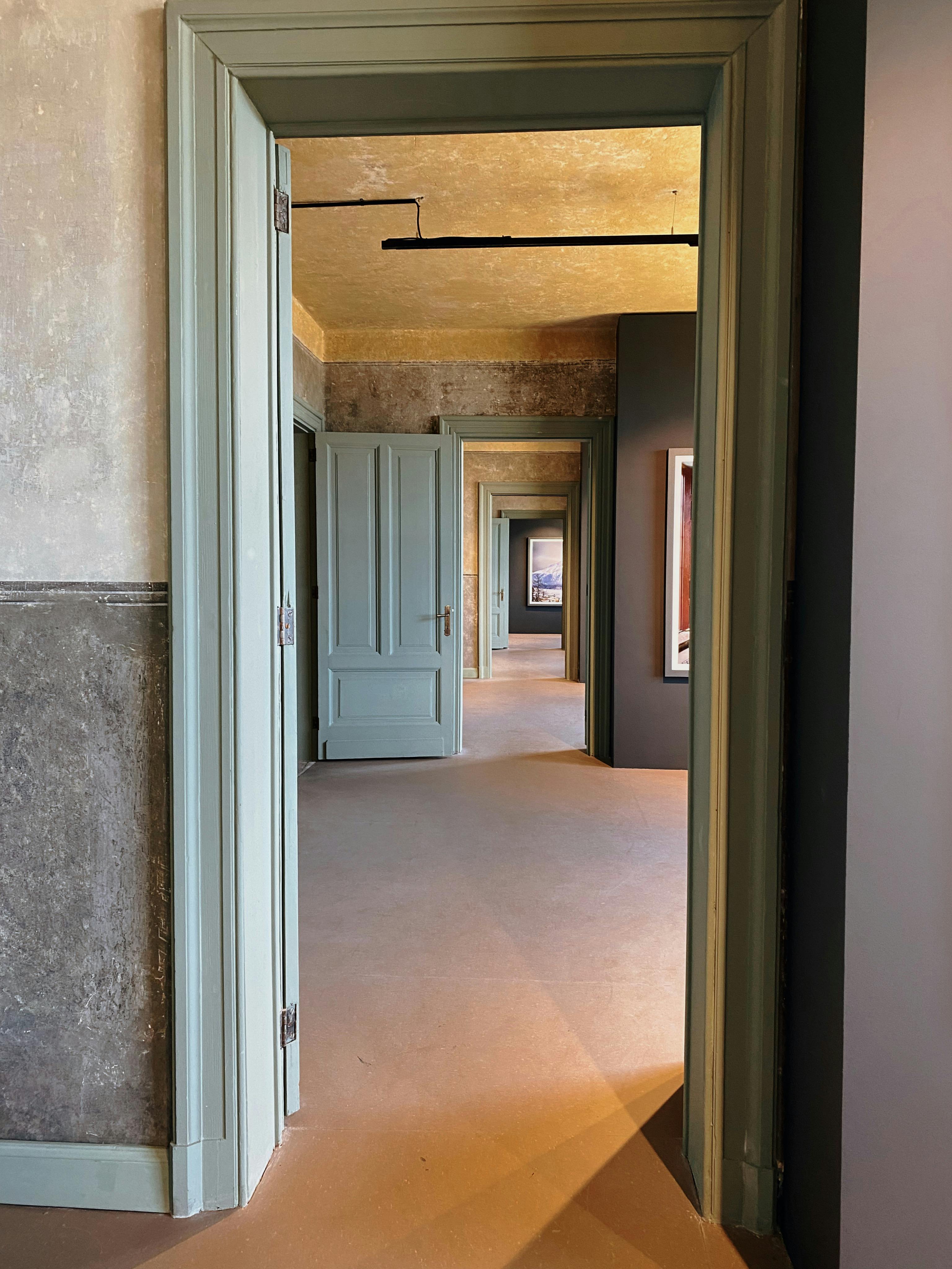 A long hallway with a door that is open