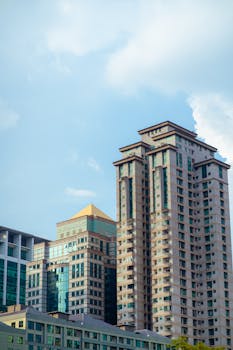 Skyscrapers against a bright blue sky, showcasing urban architecture elegance.