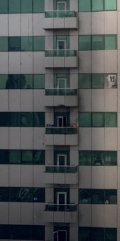 Facade of a modern Dubai apartment building showing signs of fire damage.