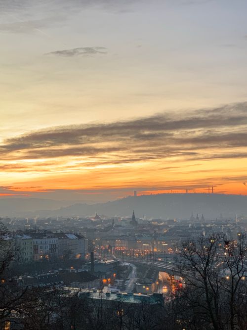 Free A breathtaking view of Prague's skyline during twilight with a vibrant sunset. Stock Photo