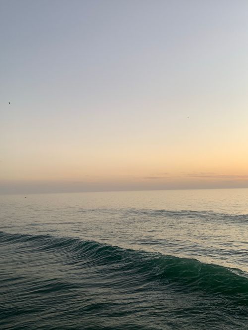 Free Peaceful ocean scene in Morocco with waves and a serene sunset sky. Stock Photo