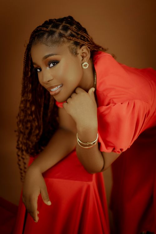 Free Beautiful portrait of a smiling woman in a vibrant red dress, showcasing elegance and style. Stock Photo