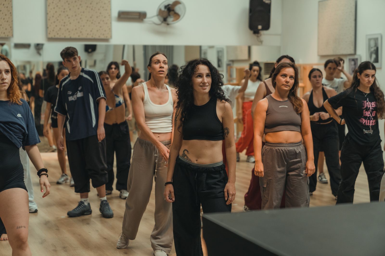 Adults practising together in a bright mirrored dance studio