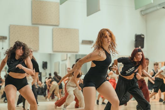 Energetic dance session in a modern studio with diverse adult dancers captured in motion.