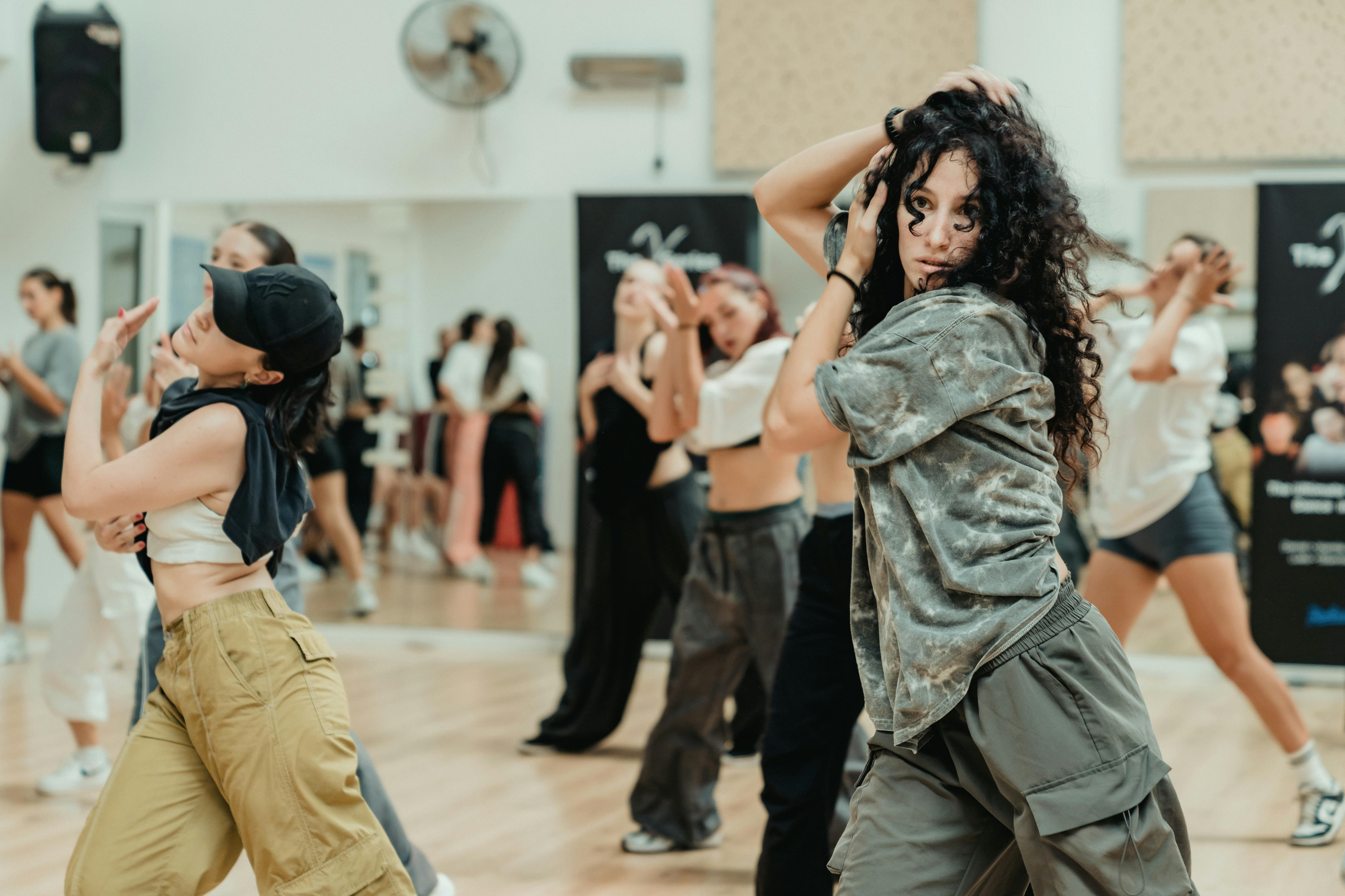A lively dance class with energetic participants showcasing diverse styles and dynamic movements.