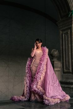 Model poses in an opulent couture gown, exuding sophisticated fashion style.