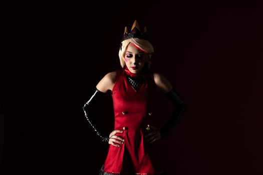 Artistic cosplay portrait of a character with vibrant red costume and crown, set against a dark background.