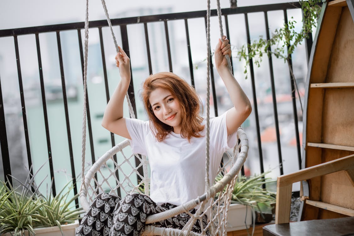 Free Woman in White Top Riding Swing Chair Stock Photo