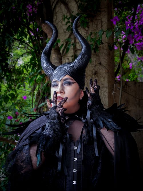 Free Captivating Maleficent cosplay with intricate details in a floral garden setting. Stock Photo