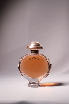 A sophisticated photo of an Olympea perfume bottle with elegant lighting.