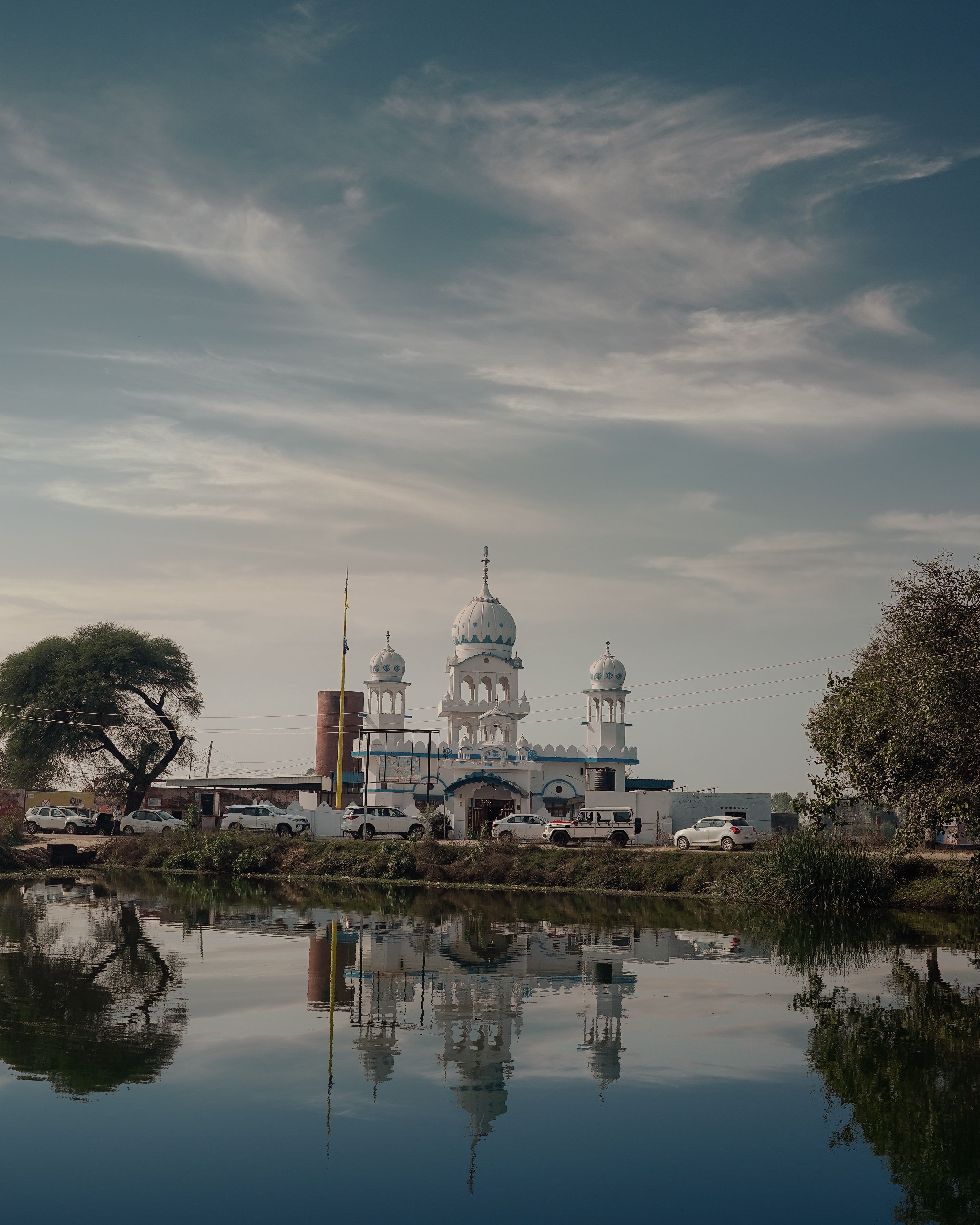 Beautiful reflection of a Sikh Gurudwara near Amritsar, Punjab on a serene day.
