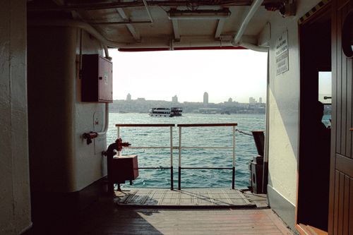 Free View of city skyline from inside a ferry, showcasing marine travel. Stock Photo