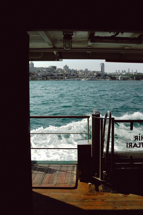 Free Scenic view of city skyline and water from inside a ferry, captured in daylight. Stock Photo