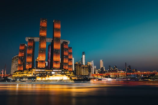 Captivating night view of Chongqing skyline, featuring modern skyscraper lighting and vibrant river reflections.