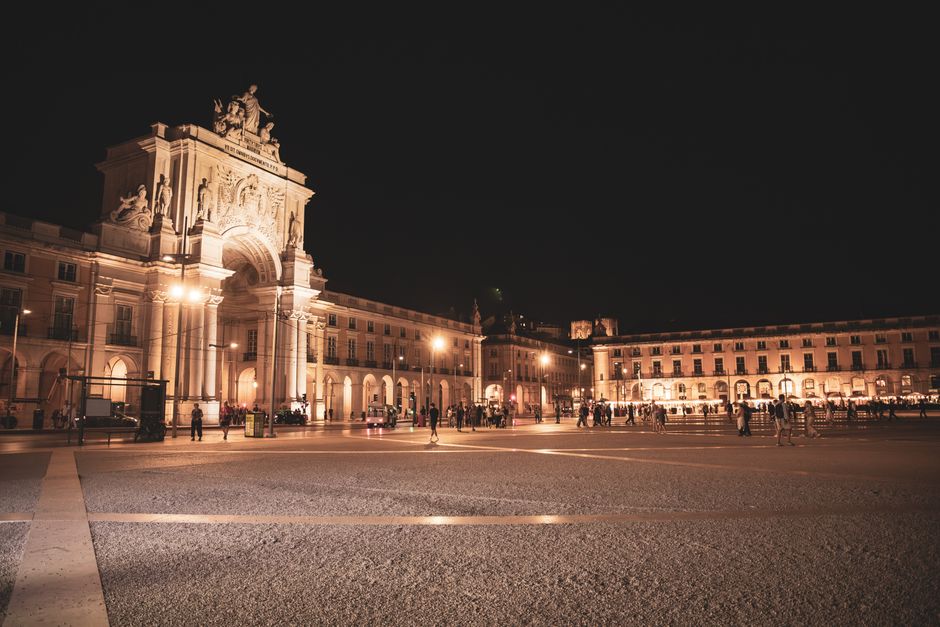 A nighttime view of the iconic Commerce Square in Lisbon, Portugal, with historical architecture illuminated by streetlights. — Terreiro, Portugal.