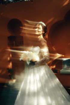 A bride in a flowing gown captured with intentional motion blur creating an artistic effect.