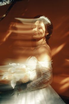 Creative bridal portrait with motion blur effect, featuring a bride holding a bouquet.