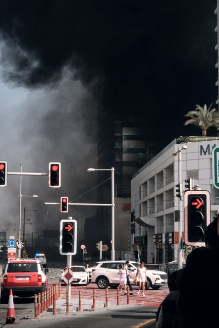 When evacuating a smoke-filled room, what is the safest way to move?