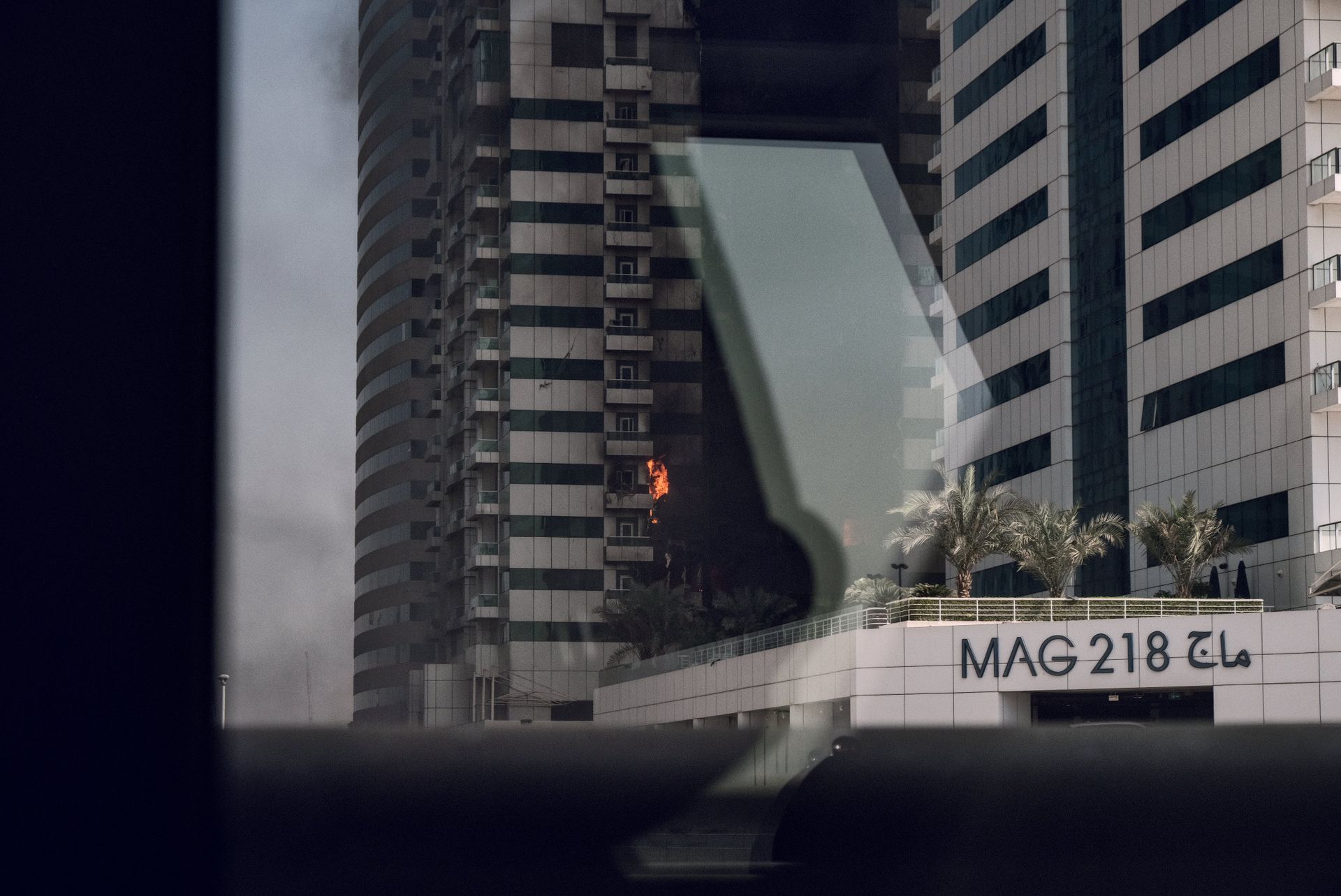 Fire incident at MAG 218 in Dubai seen from a vehicle window.