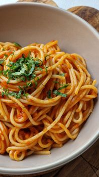 Bowl of spaghetti served with rich tomato sauce and fresh herbs, perfect for a cozy dinner.
