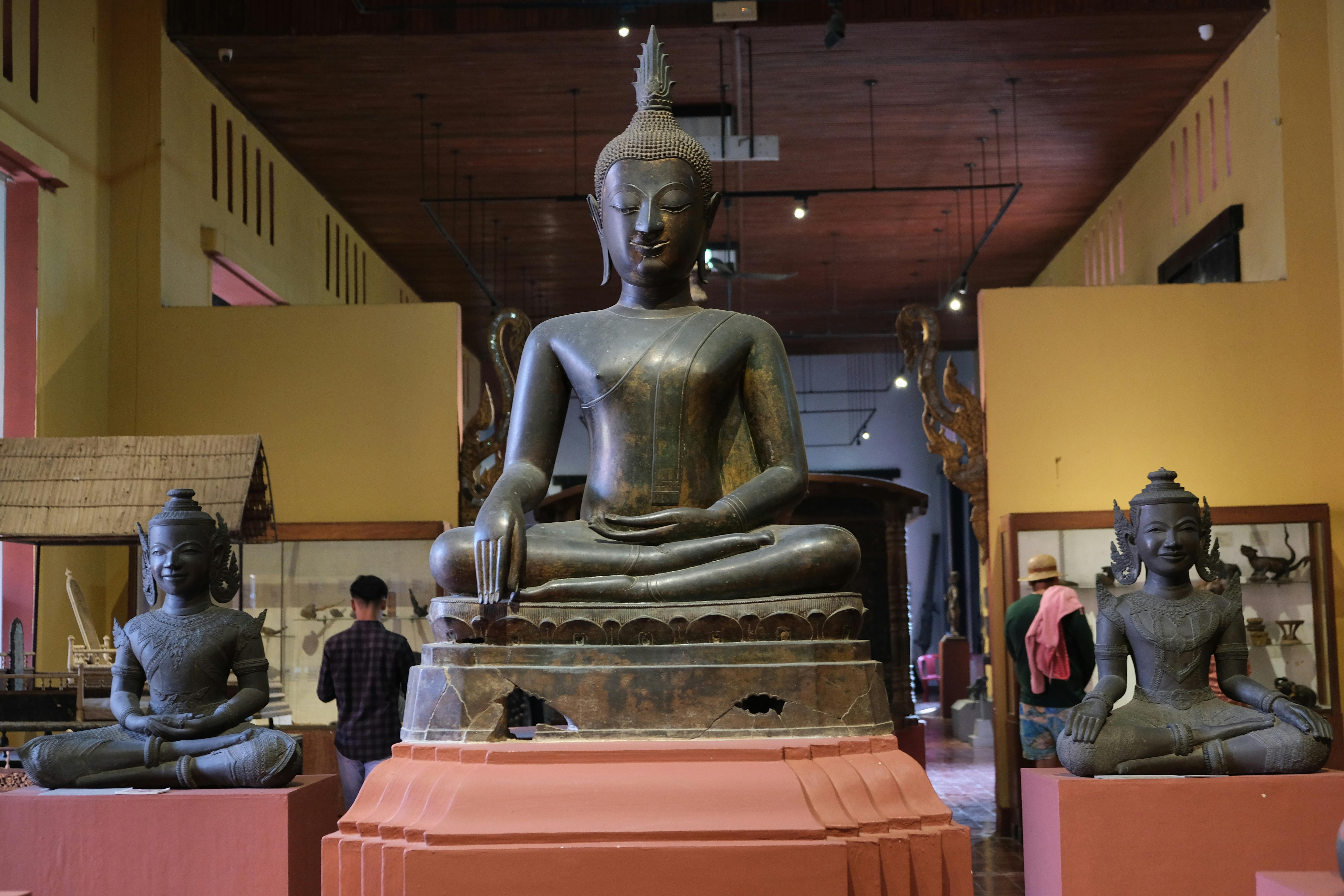 Serene buddha statues on display in a Cambodian museum interior