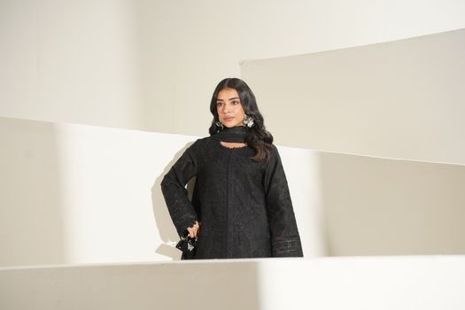 Elegant black dress captured in a modern fashion shoot indoors in Lahore, Pakistan.