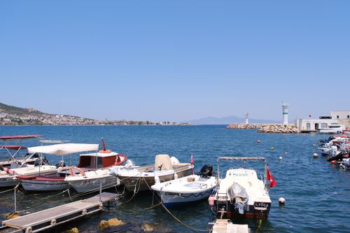 Free Boats docked at a picturesque harbor in Foça, İzmir, Türkiye on a sunny day. Stock Photo