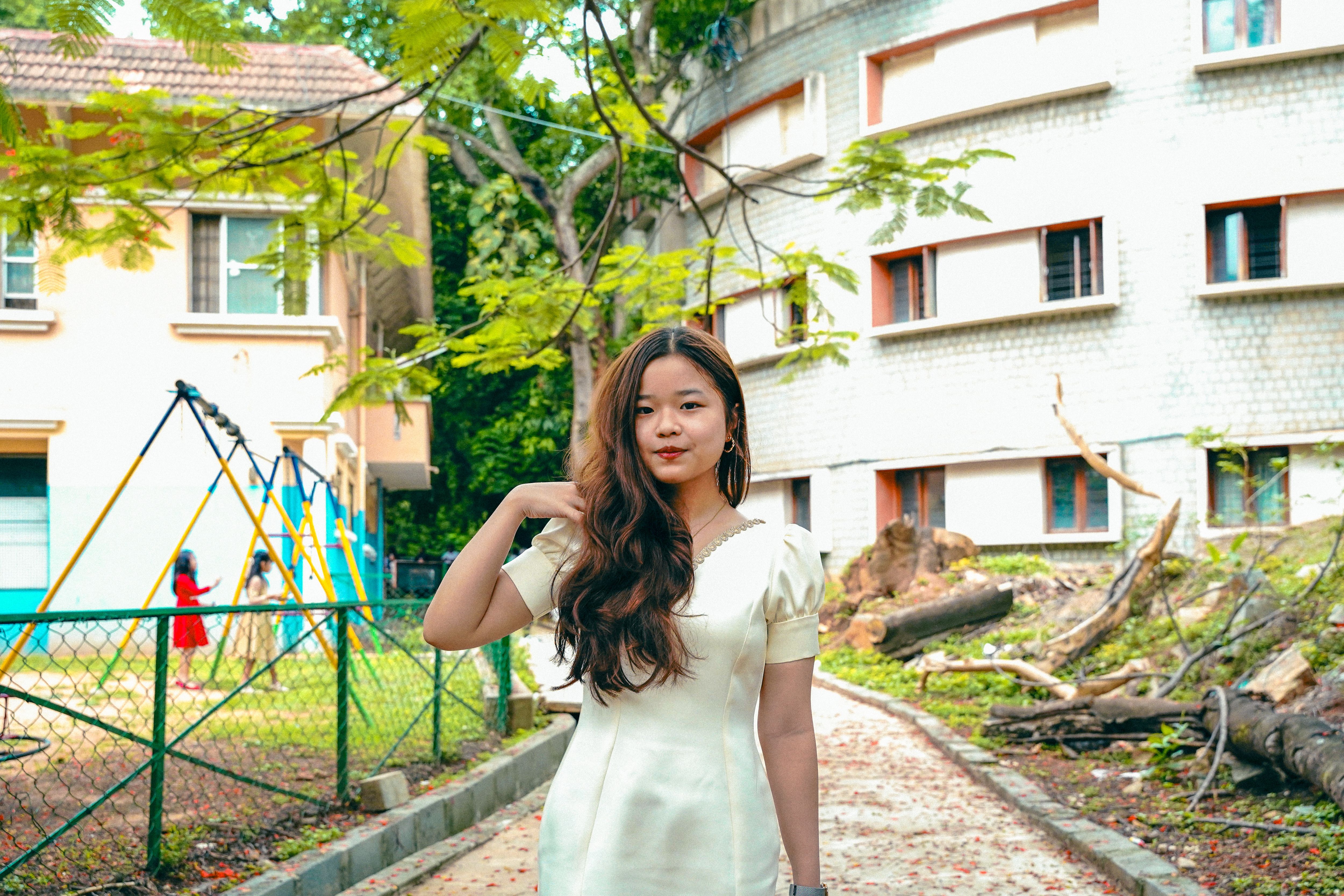 Young Woman Posing in Urban Park Setting · Free Stock Photo