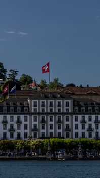 Image of the iconic Schweizerhof Hotel with a Swiss flag, showcasing Swiss architecture and tourism.