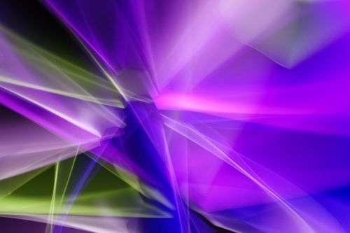 Free Dynamic abstract image with vibrant purple and green light streaks on a dark background. Stock Photo