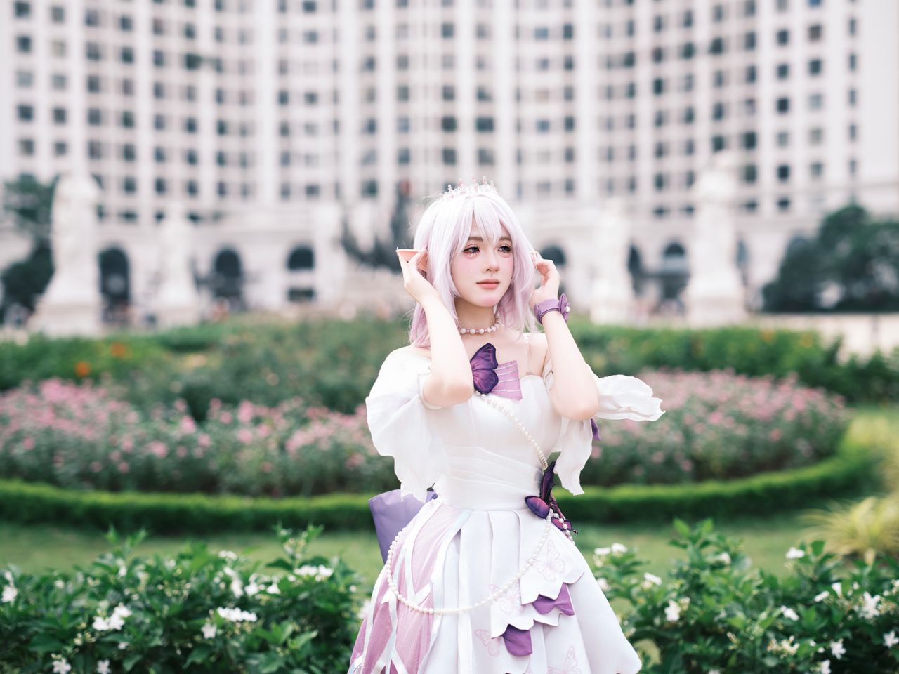 a captivating portrait of a cosplayer in a garden with an elegant back