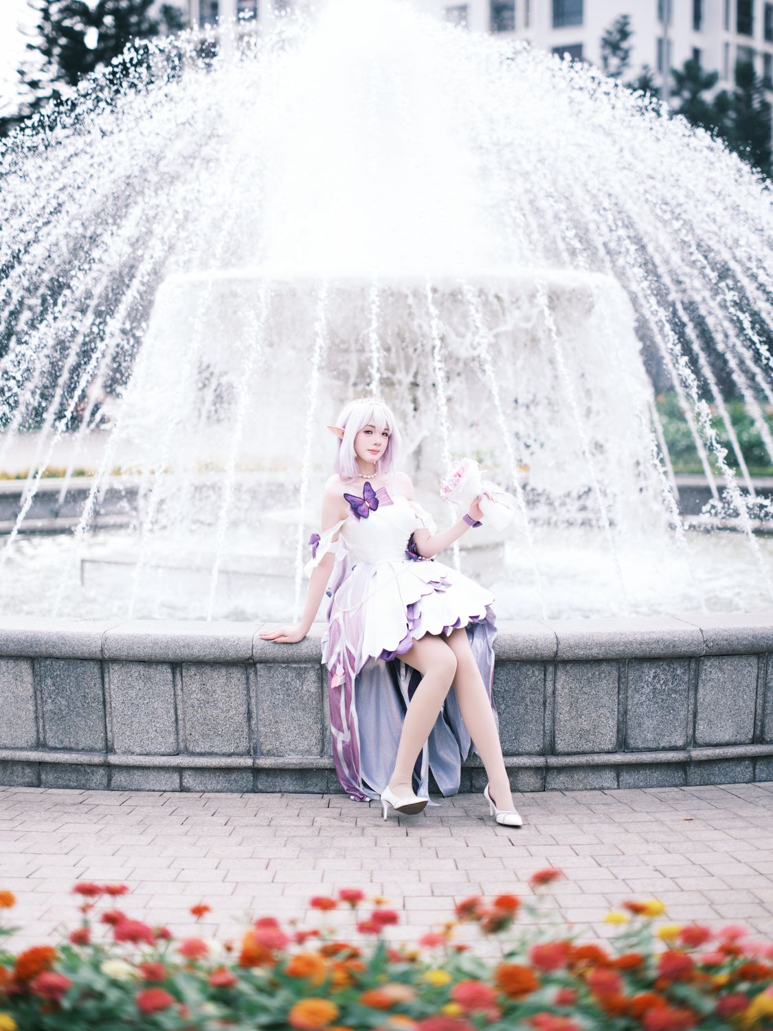 Elegant Cosplay by Fountain with Spring Flowers · Free Stock Photo