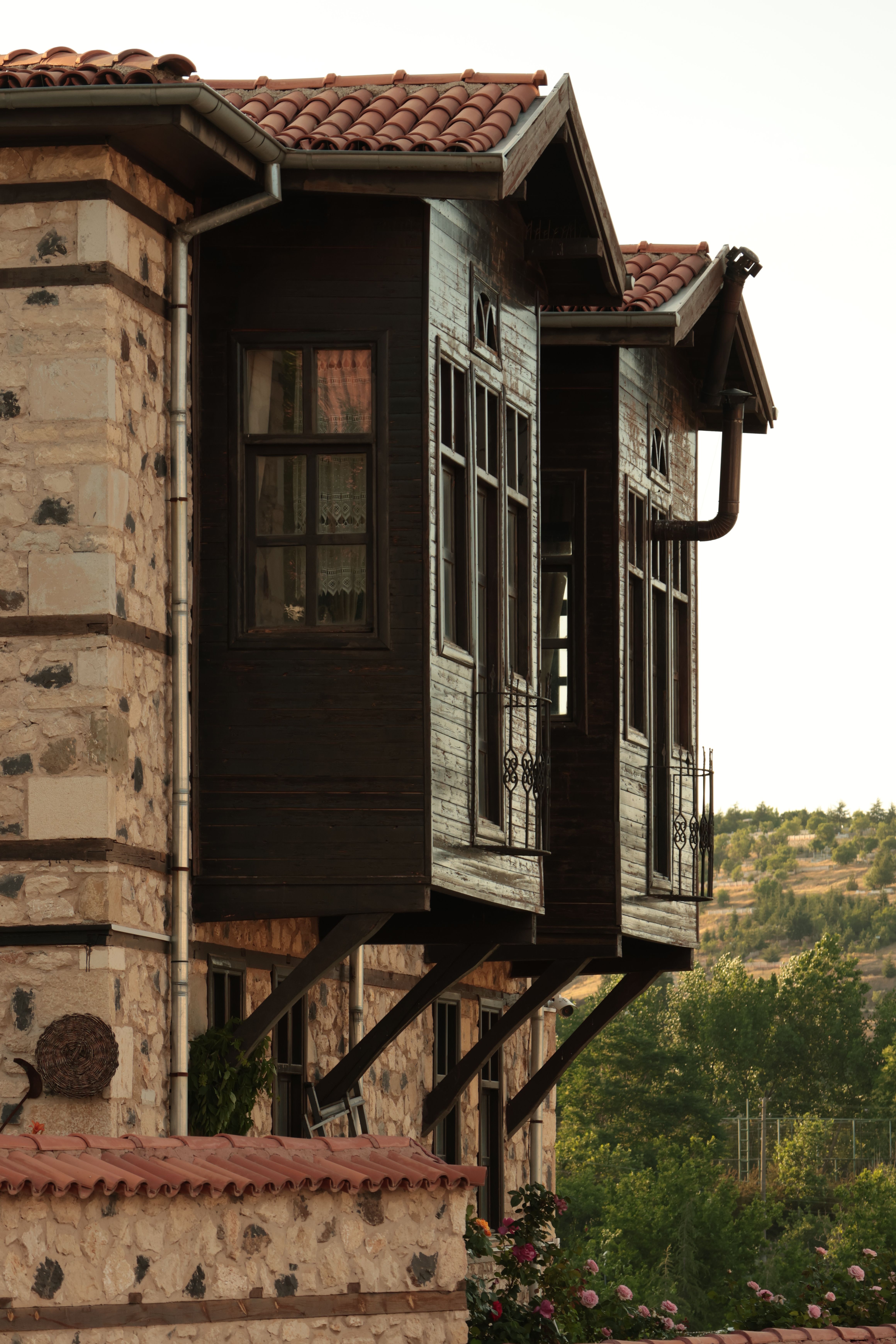 Rustic Stone House with Wooden Windows at Sunset · Free Stock Photo