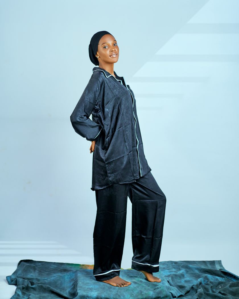 A navy piped pyjama set — shirt and trousers — worn full length