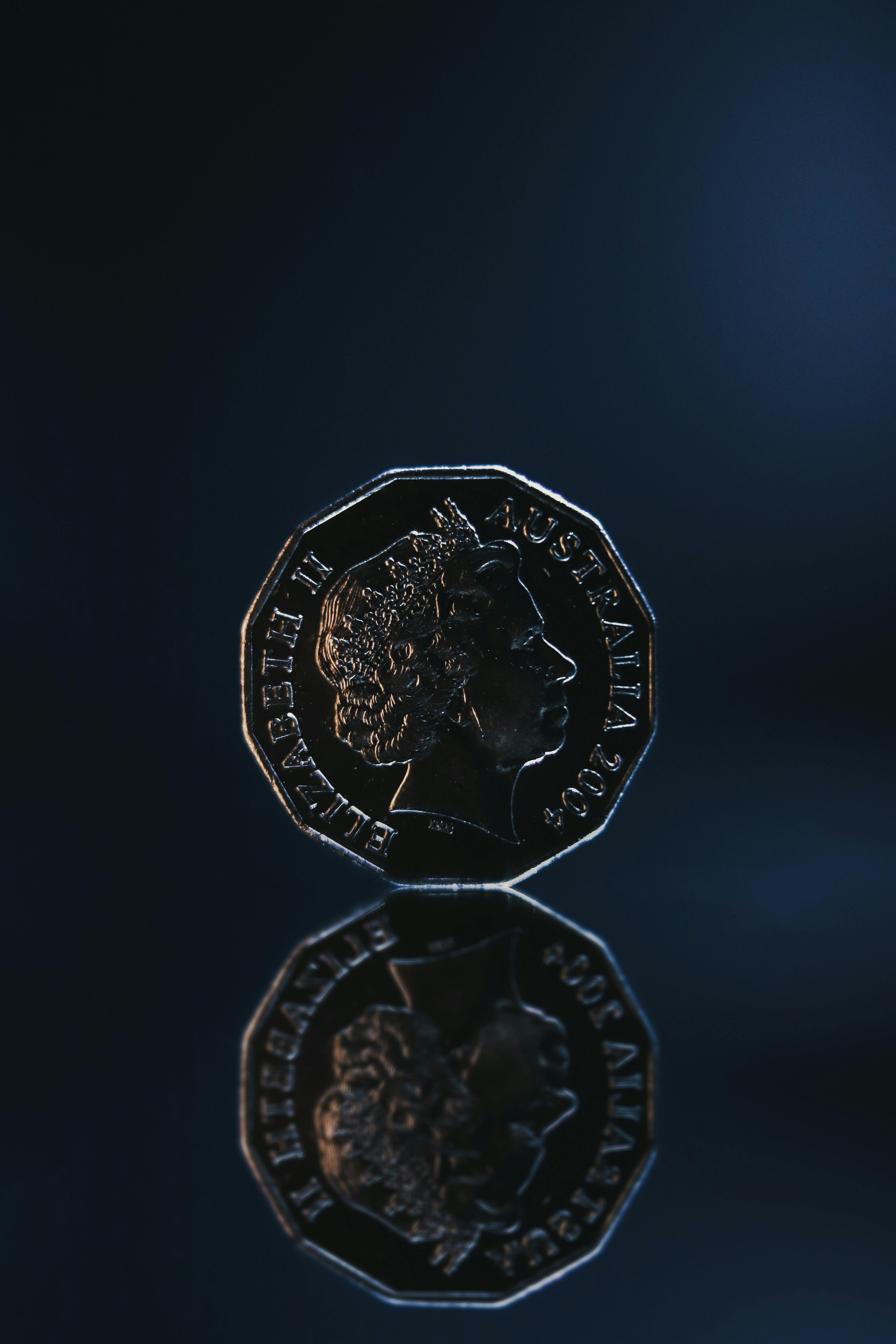 reflection of old coin placed on blue background