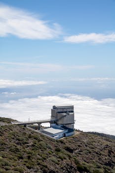 Stunning aerial view of a La Palma observatory with clouds below.