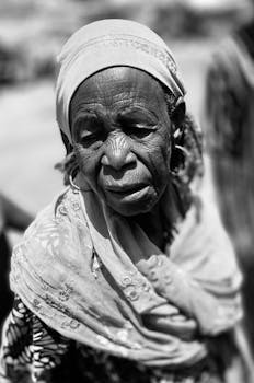 A striking black and white portrait of an elderly woman, reflecting wisdom and grace.