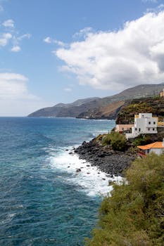 Beautiful coastline with vibrant blue sea and rugged cliffs in La Palma, Región de Murcia, Spain.