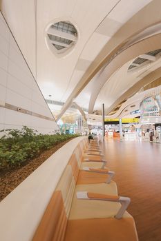 Wide-angle view of the modern interior design at Abu Dhabi Airport, United Arab Emirates.